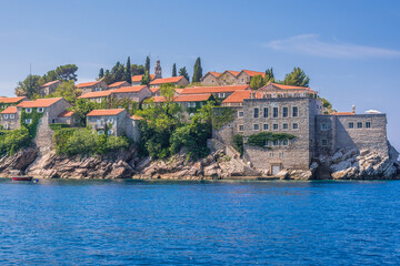 Fototapeta na wymiar Buildings on Sveti Stefan isle on Adriatic shore in Montenegro