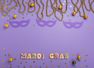 Mardi Gras King Cake Muffins or Cupcakes, Carnival Masks on Purple Background.