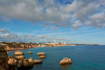 Naklejka na ściany i meble Beautiful view of the sweeping coastline from Alvor to Portimao in Algarve, Portugal