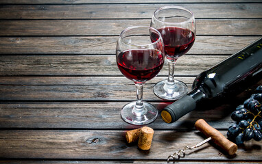 Wine background. Red wine in glasses with grapes.