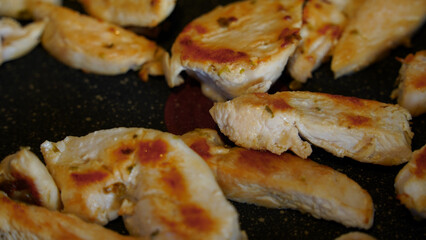 Fried chicken, stir-fried spicy chicken breast. The chicken looks Spicy fried and delicious. Man shaking the pan