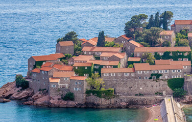 Fototapeta na wymiar Buildings on Sveti Stefan islet on the Adriatic coast in Montenegro