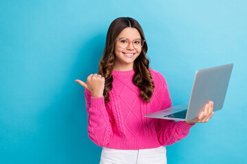 Photo of young it coder school girl wear pink knitted pullover hold computer finger point mockup...