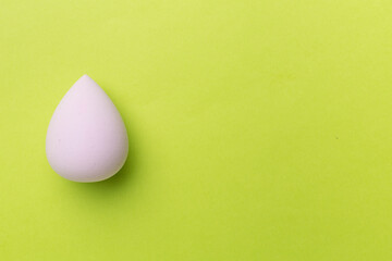 Beauty blender on color background, top view