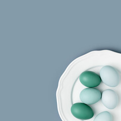 Chicken eggs with colored eggshells on white plate. Minimal style natural eggs on blue colored background. Benefits eggs as healthy protein food. Above view monochrome trend aesthetic photo, copyspace