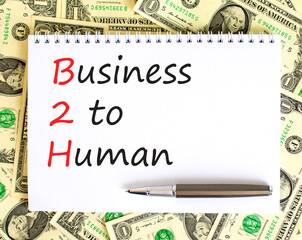 B2H business to human symbol. Concept words B2H business to human on white note on a beautiful background from dollar bills. Business and B2H business to human concept. Copy space.