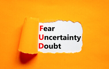 FUD fear uncertainty doubt symbol. Concept words FUD fear uncertainty doubt on white paper on a beautiful orange background. Business and FUD fear uncertainty doubt concept. Copy space.