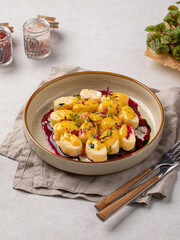 Portion of lazy dumplings with vanilla and cherry sauce