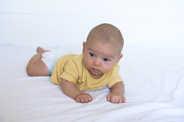 Baby lying on the white bed