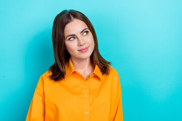 Photo of satisfied gorgeous positive woman with straight hairdo wear yellow shirt look empty space isolated on blue color background