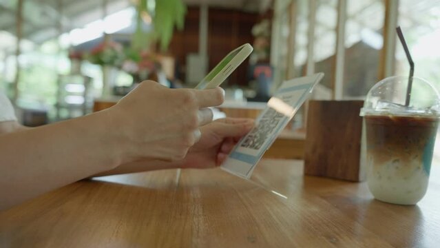 Woman use smartphone to scan QR code to pay in cafe restaurant with a digital payment without cash. Choose menu and order accumulate discount. E wallet, technology, pay online, credit card, bank app.