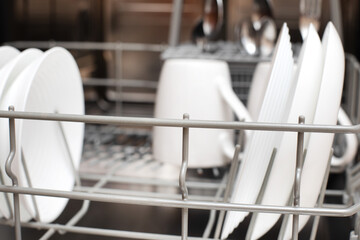 Fototapeta premium Clean dishes are in the dishwasher. The concept of cleaning dirty dishes and glasses