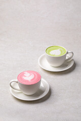 Side view on two cups of different matcha latte drinks
