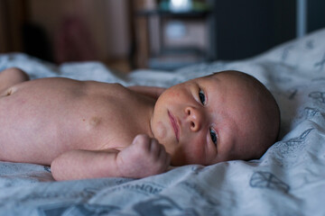 newborn baby boy naked in the bed