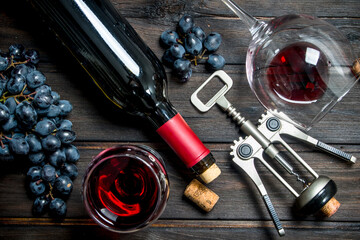 Wine background. Red wine with corkscrew.