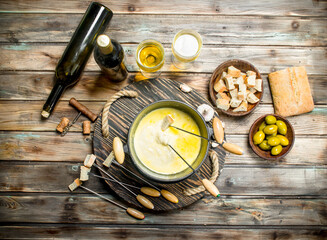 Delicious fondue cheese with olives and white wine.