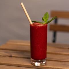 Fresh cold pressed smoothie juice fruit on wooden table soft background bamboo straw colorful ice cold 