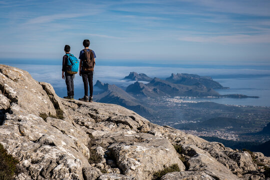 two young people observing the bay of Alcudia from a top, Escorca, Mallorca, Balearic Islands, Spain