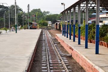 Naklejka premium View of Toy train Railway Tracks from the middle during daytime near Kalka railway station in India, Toy train track view, Indian Railway junction, Heavy industry
