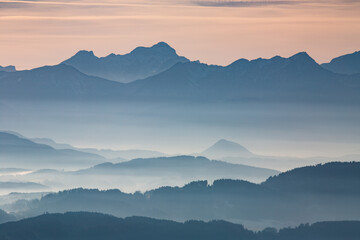 Sunset seen from Lorenziberg over the carithian valleys towards the karawanken mountain range and...
