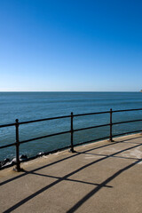 Fototapeta na wymiar Railings,sunshine,blue sky and sea, simple graphic composition.