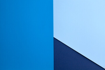 Multilayered colored paper background in blue tones. Abstract geometric flat composition.Empty space on multicolored cardboard. Diagonal, triangules and lines. Top view...