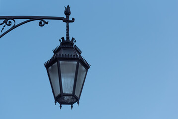 Fototapeta na wymiar Wall mounted wrought iron street light isolated against background