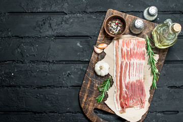 Raw bacon with rosemary and spices.