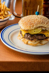 Hamburger. Bacon Cheeseburger. Classic traditional American bar, restaurant entree. Beef hamburger with Swiss and cheddar cheeses served with lettuce, tomato, onion and hand cut french fries. 