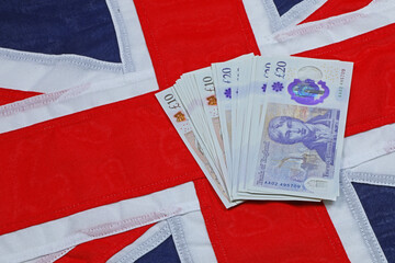 A plan view of spread of ten and twenty pound notes on a Union Jack.