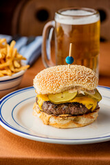 Hamburger. Bacon Cheeseburger. Classic traditional American bar, restaurant entree. Beef hamburger with Swiss and cheddar cheeses served with lettuce, tomato, onion and hand cut french fries. 