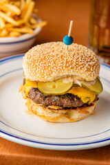 Hamburger. Bacon Cheeseburger. Classic traditional American bar, restaurant entree. Beef hamburger with Swiss and cheddar cheeses served with lettuce, tomato, onion and hand cut french fries. 