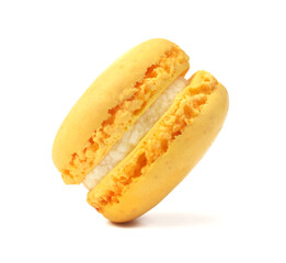 Popular French cake closed up isolated on white. Yellow citron macaroon with cream filling are flying.