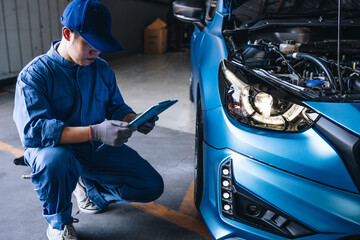 Maintenance worker checking tire service via insurance system at garage, Safety vehicle to reduce accidents before a long travel, road trip transportation.