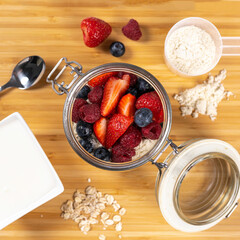 Smoothie yoghurt bowl healthy colorful banana, oat, strawberry, blueberry, raspberry, spoon, table, top down, breakfast, vibrant, organic, seeds