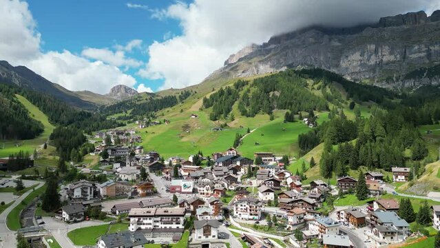 Arabba drone view in summer with the Pordoi Pass and Campolongo Pass