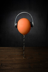 Dark background with orange balloon in a realistic style.