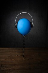 Dark background with blue balloon in a realistic style.