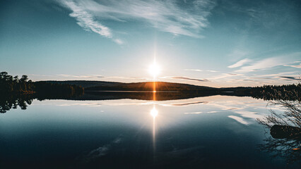 midnight sun at a calm lake