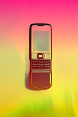 Old mobile phone in thermography gradients. retro, vintage and nostalgia style. Y2K design trend