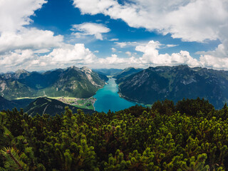 Fototapeta premium Austrian glacier water sea mountains lake landscape nature drone shot clouds sky green village alaska norway fjord blue forest 