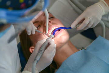 Concept of dentistry.A woman at a dentist's appointment to replace arches with braces.