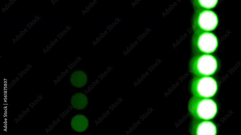 Wall mural falling lines of green round bokeh. lines made up of circles move abstractly from top to bottom and 