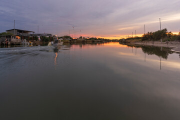 Fototapeta premium Nice view of fishing huts on river at sunset,italian fishing machine, called 