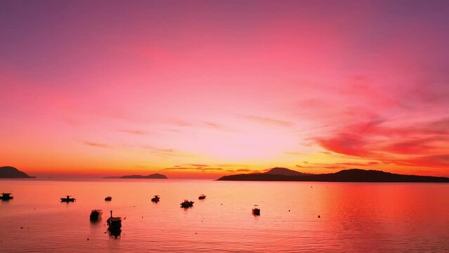 aerial view stunning red sky in the morning above Andaman sea ..scenic reflection of beautiful sunshine in the sea. .4k stock footage video in travel concept. bright sky background.