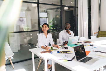 Diverse colleagues working in modern conference room and laughing