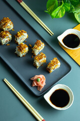 Sushi rolls, Chopsticks and sauce on a plate