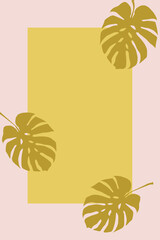 Fototapeta na wymiar Goldbraune Monstera Blätter vor einem hellrosa Rahmen und beigefarbenem Hintergrund