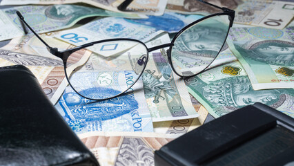 Cash money banknotes background. Photo for banner on website. Photo of accountancy or banking background. 100 zlotys, 200 zlotys, 50 zlotys. Changes in wages and taxes. Rising inflation. PLN