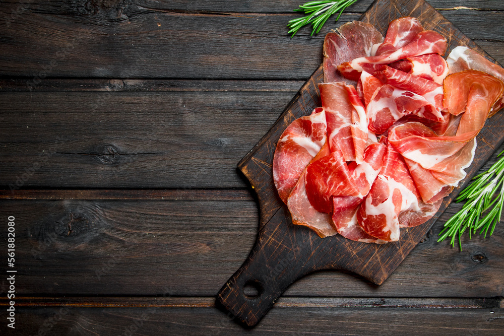 Wall mural Spanish ham on the chopping Board.